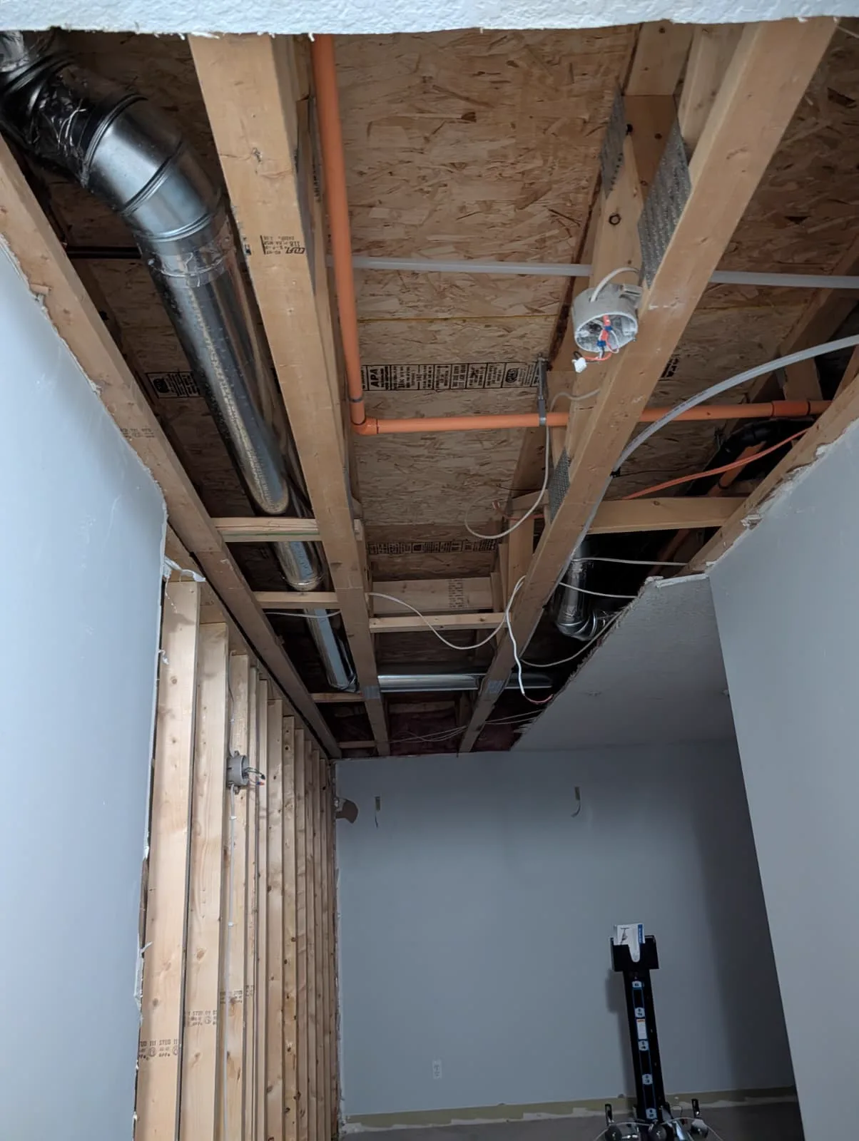 The same ceiling open, ducts and wiring exposed